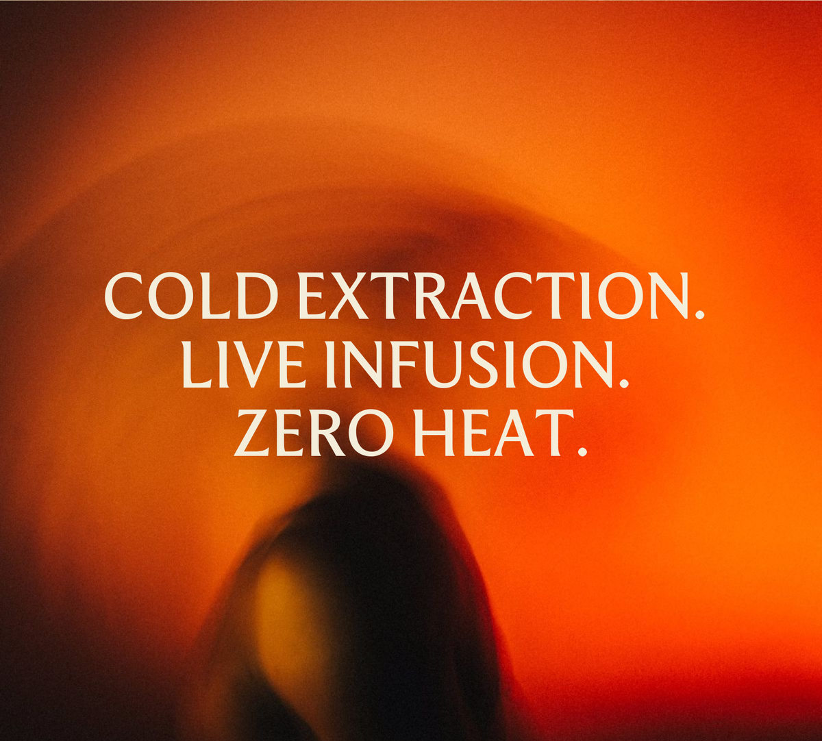 Text 'Cold Extraction. Live Infusion. Zero Heat.' on a blurred background with warm tones.