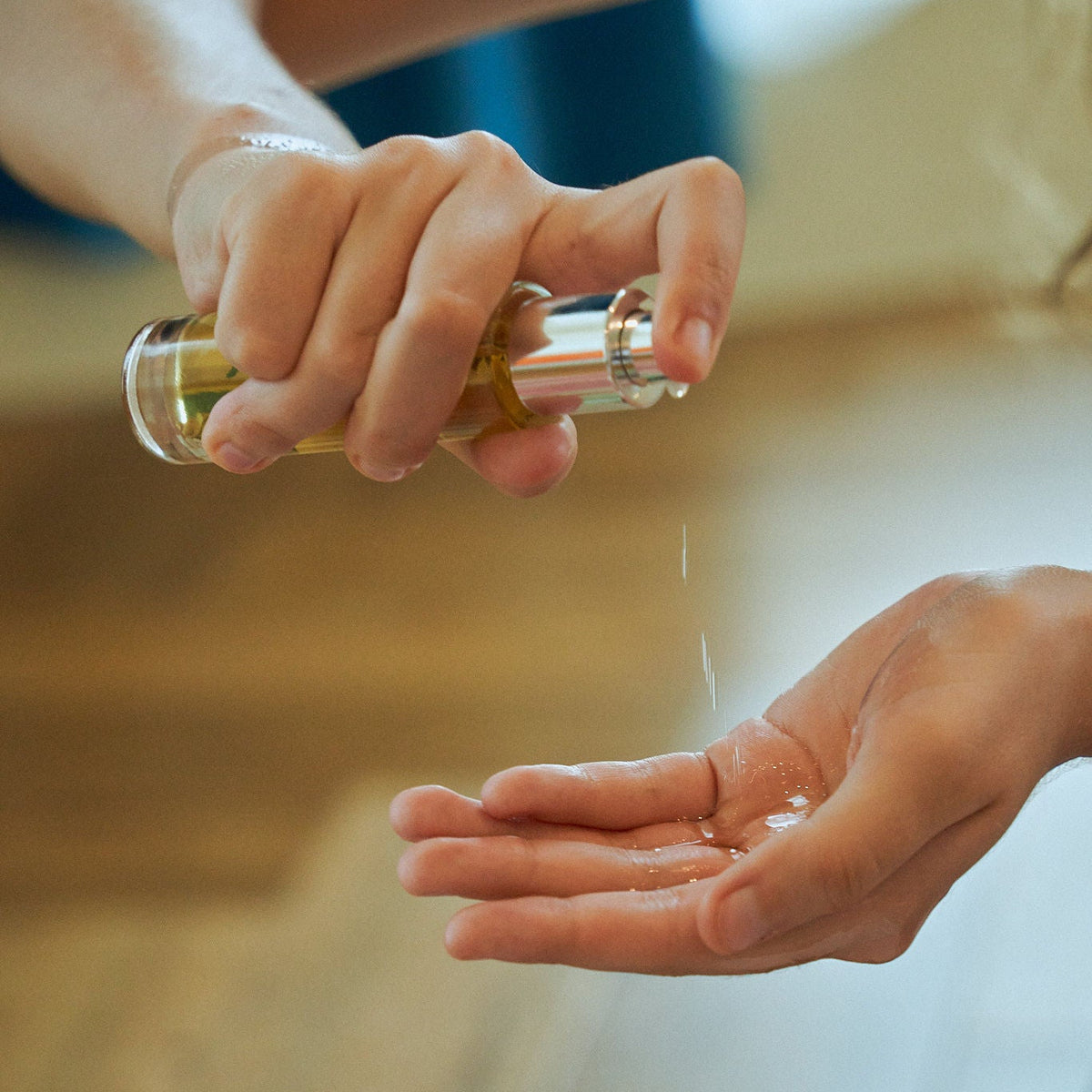 Person applying oil to their hand